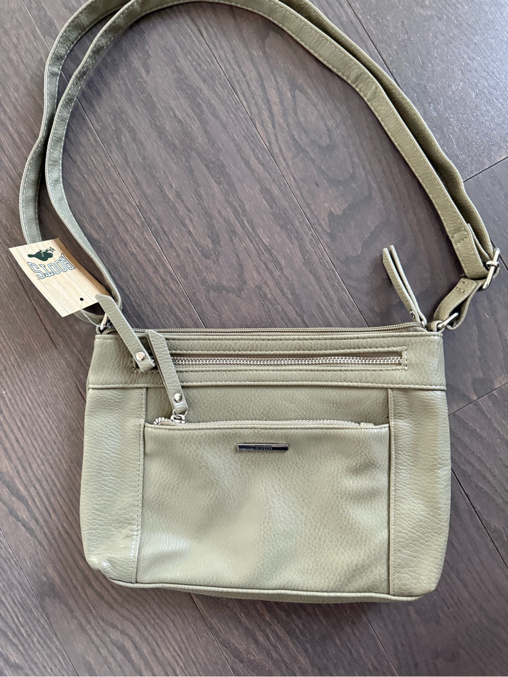 Roots-multi-zip crossbody purse finished in a sage green
